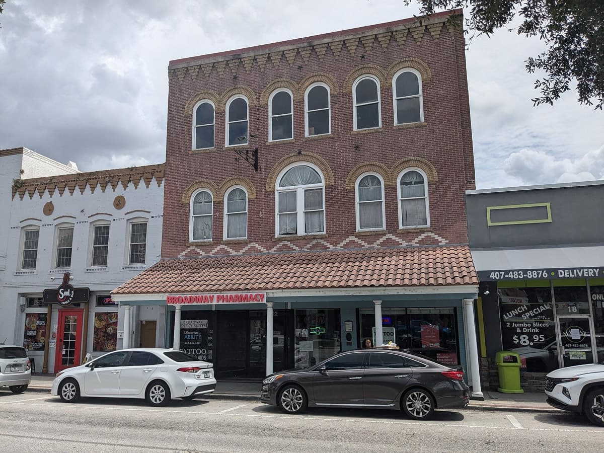A historic brick retail building on Broadway Avenue in downtown Kissimmee